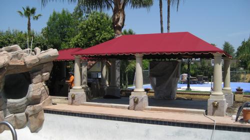 A poolside residential awning creates shade and comfort